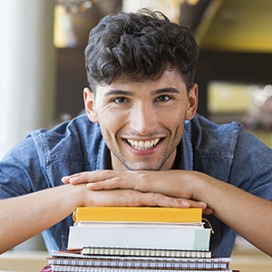 Young male patient smiling head on his hands