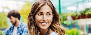 Young female patient smiling in green house