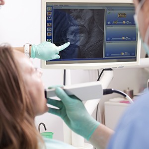 Patient and dentist examine intraoral images of smile